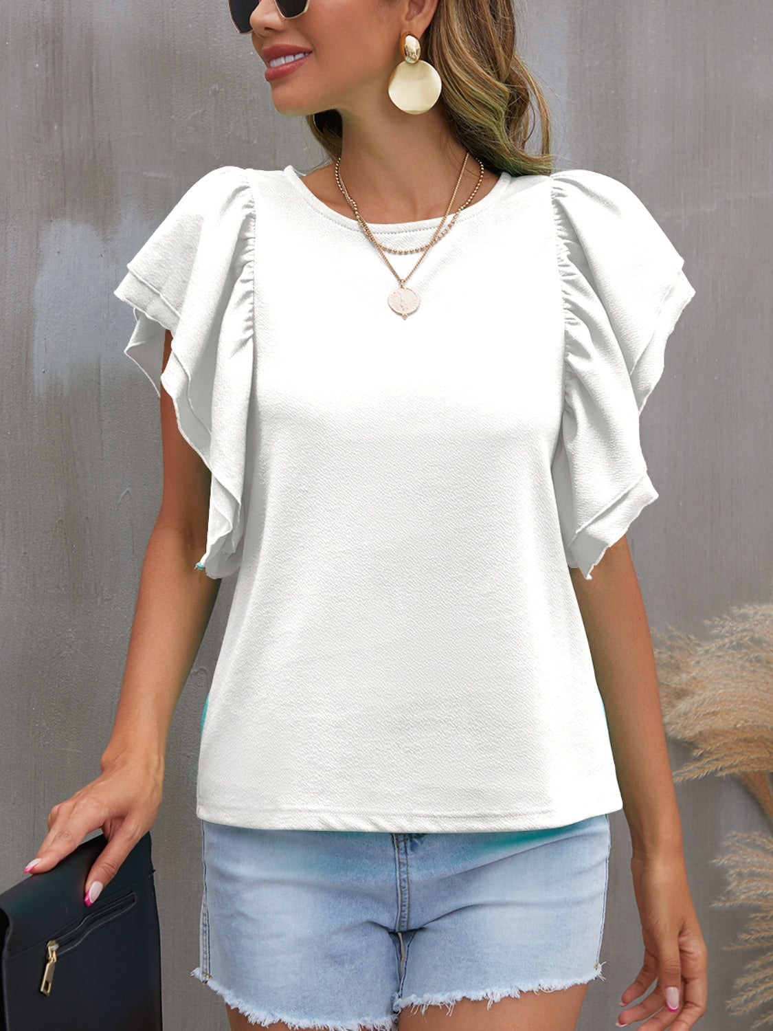 Blusa con cuello redondo y mangas con volantes