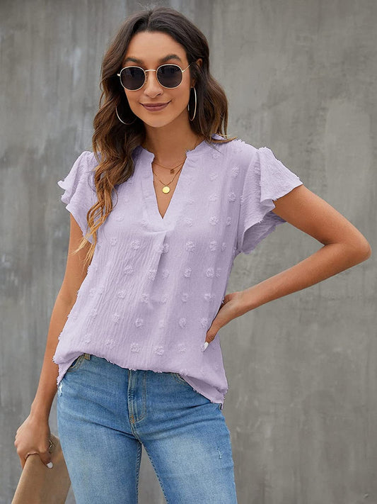 Blusa con mangas acampanadas y muescas con lunares suizos